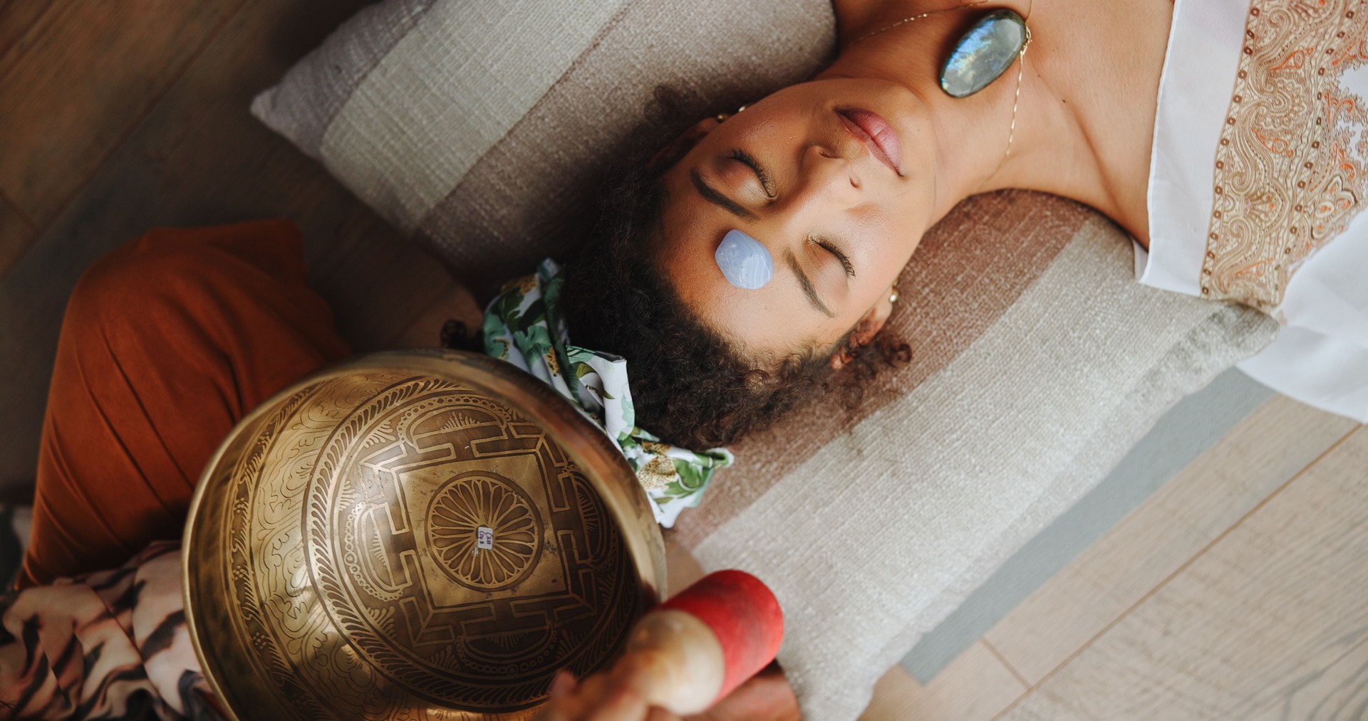 Healing, calm and woman with healer, hands or mantra for inner peace, spiritual or gemstone for chakra. Meditation, shaman or sound therapy with Tibetan singing bowl, vibration or holistic for person